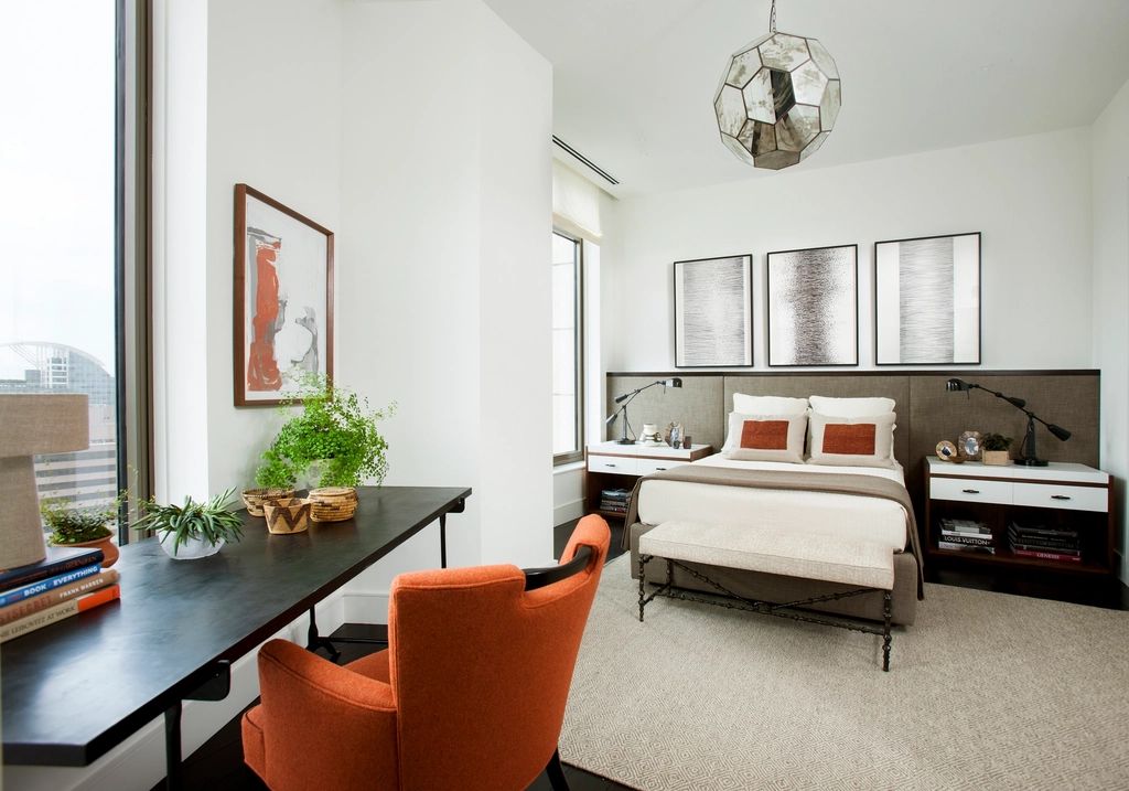 A guest room with a large bed and soft lighting